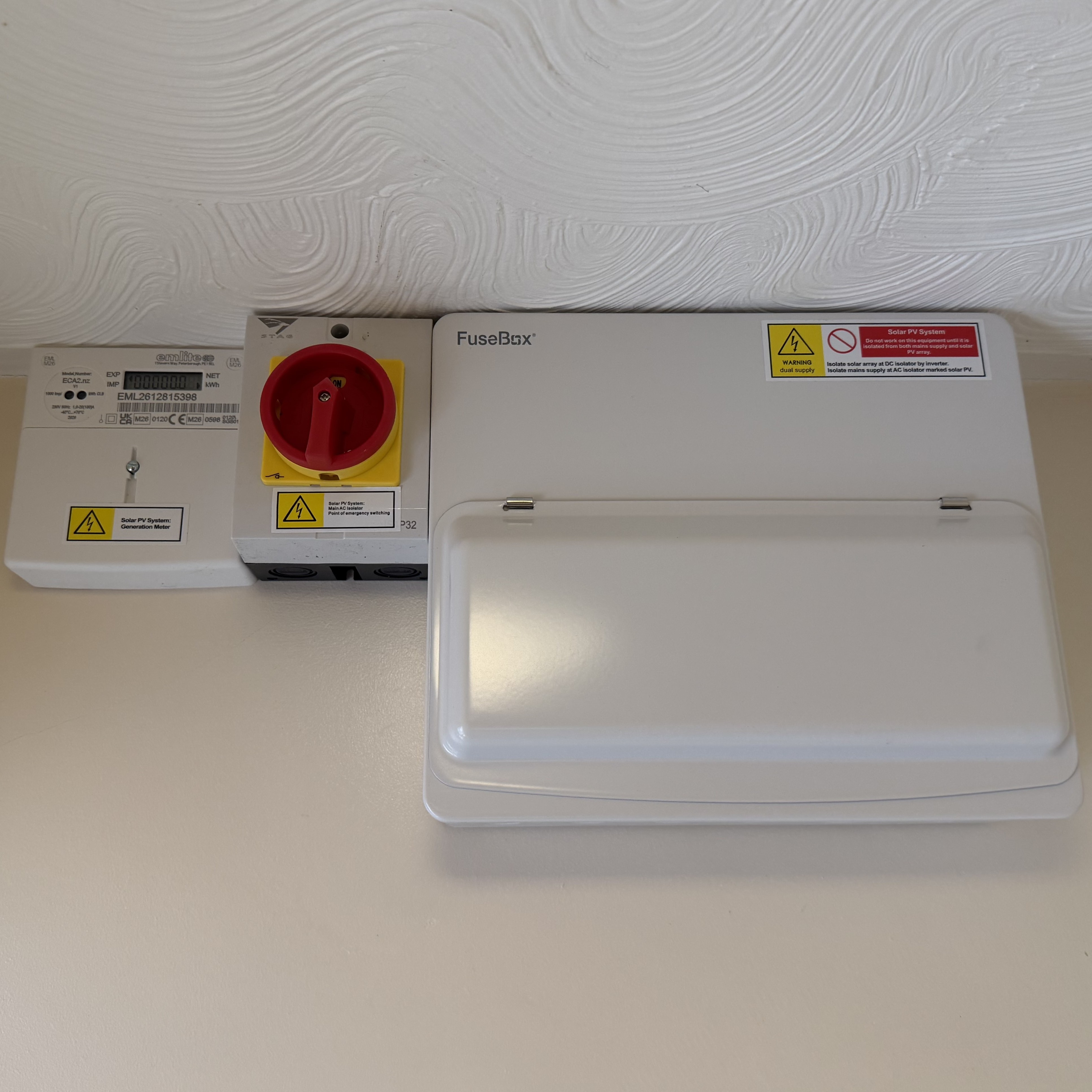 An electrician installing a consumer unit